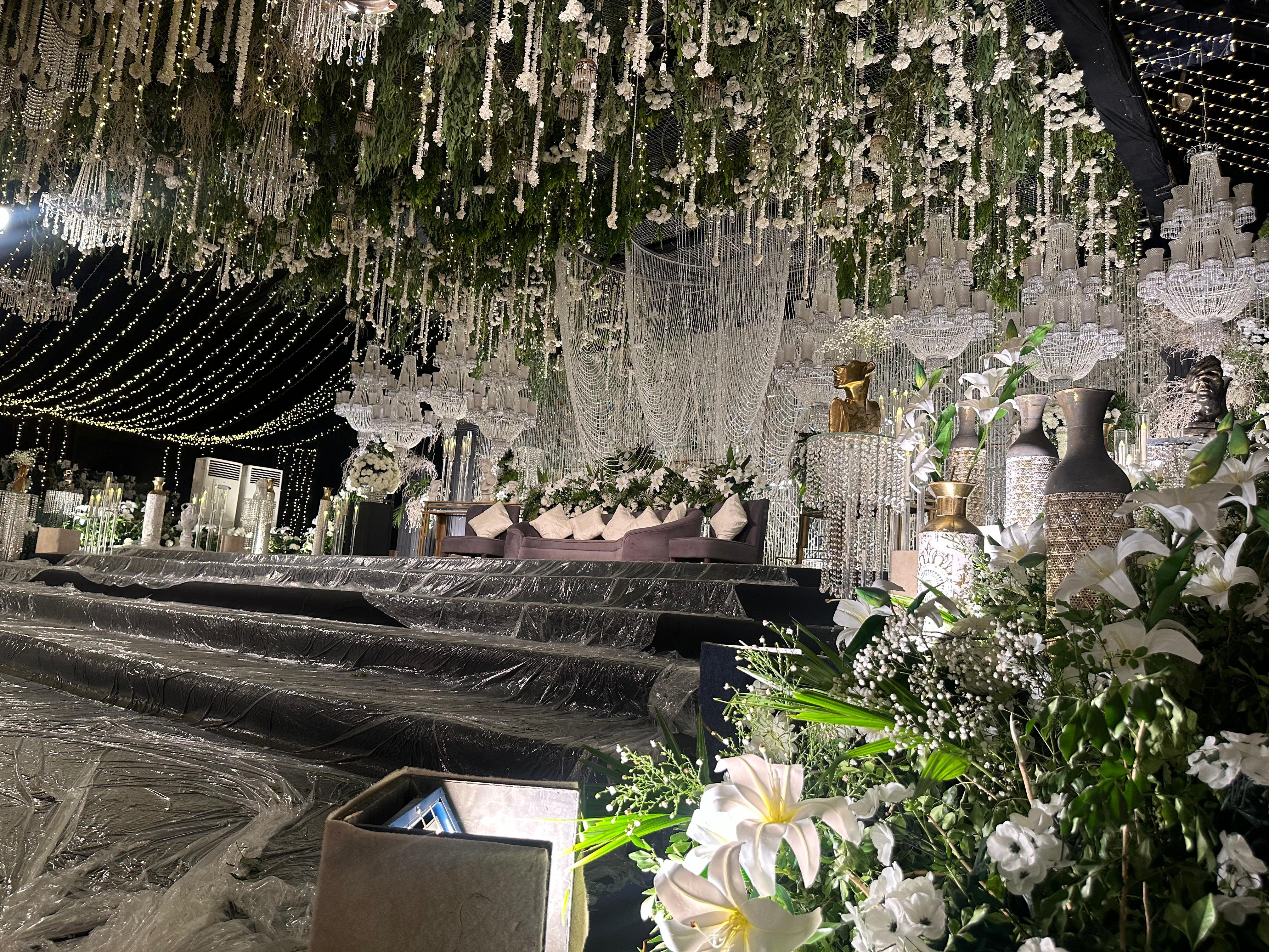 Wedding baraat stage with white and gold florals